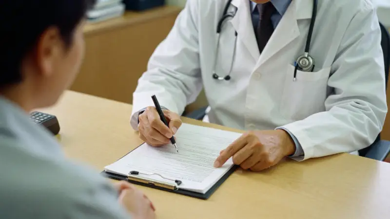 Doctor explaining insurance coverage to patient, clipboard with policy details, office setting, warm midday light