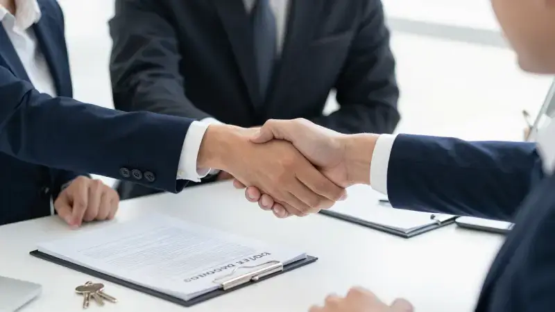 Commercial building owner meeting insurance advisor in modern office